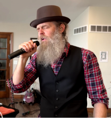 Bradley of CAKEMIX singing into wireless mic June 29, 2025